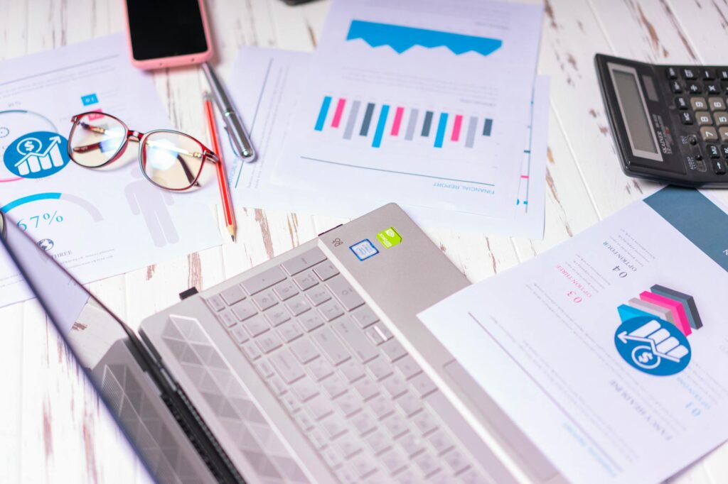 Investment papers, a calculator, and a handwritten allocation worksheet on a tidy desk