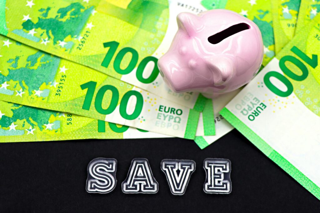 Budget papers and an emergency fund tracker placed next to an investment statement