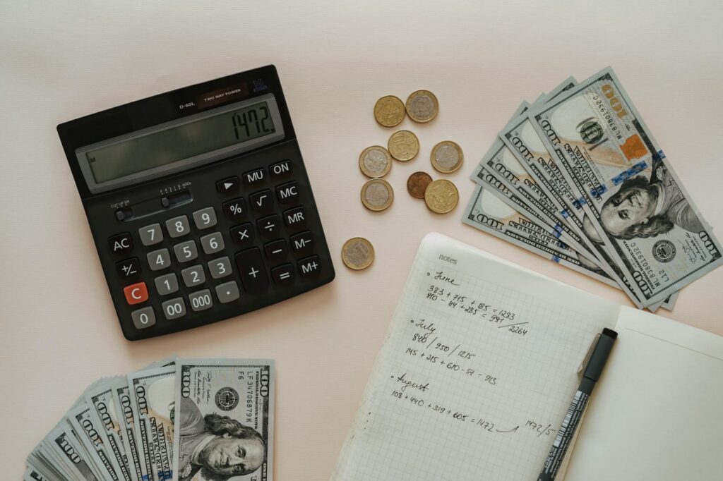 Calculator and investment documents with highlighted notes