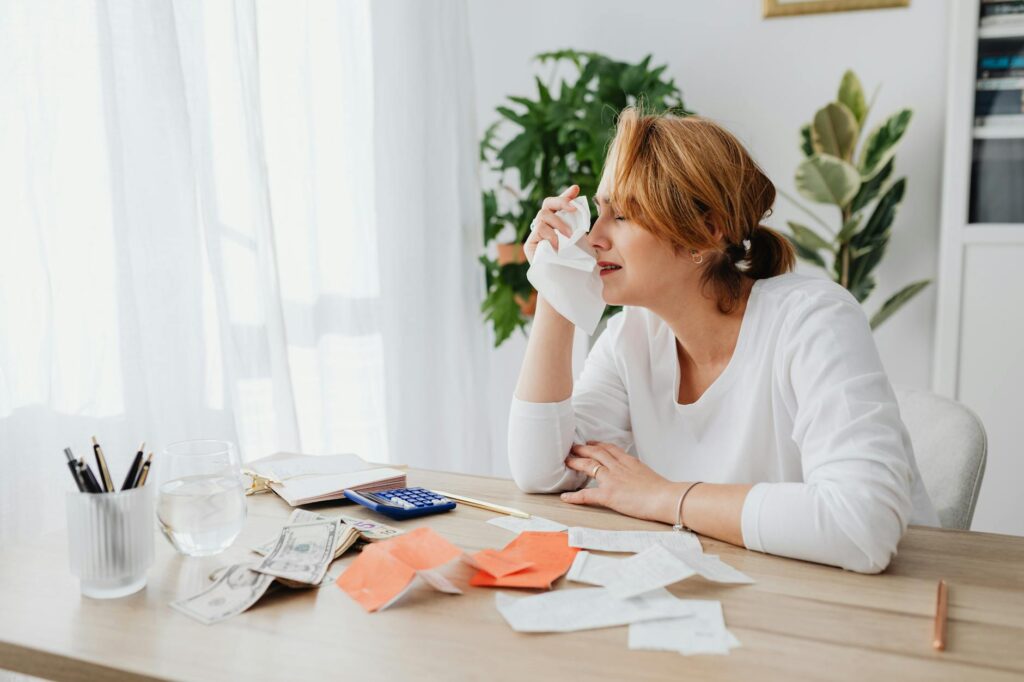 Bills and bank paperwork spread out on a kitchen table