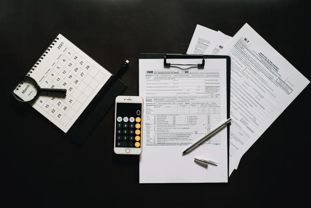 A calendar and calculator next to household paperwork