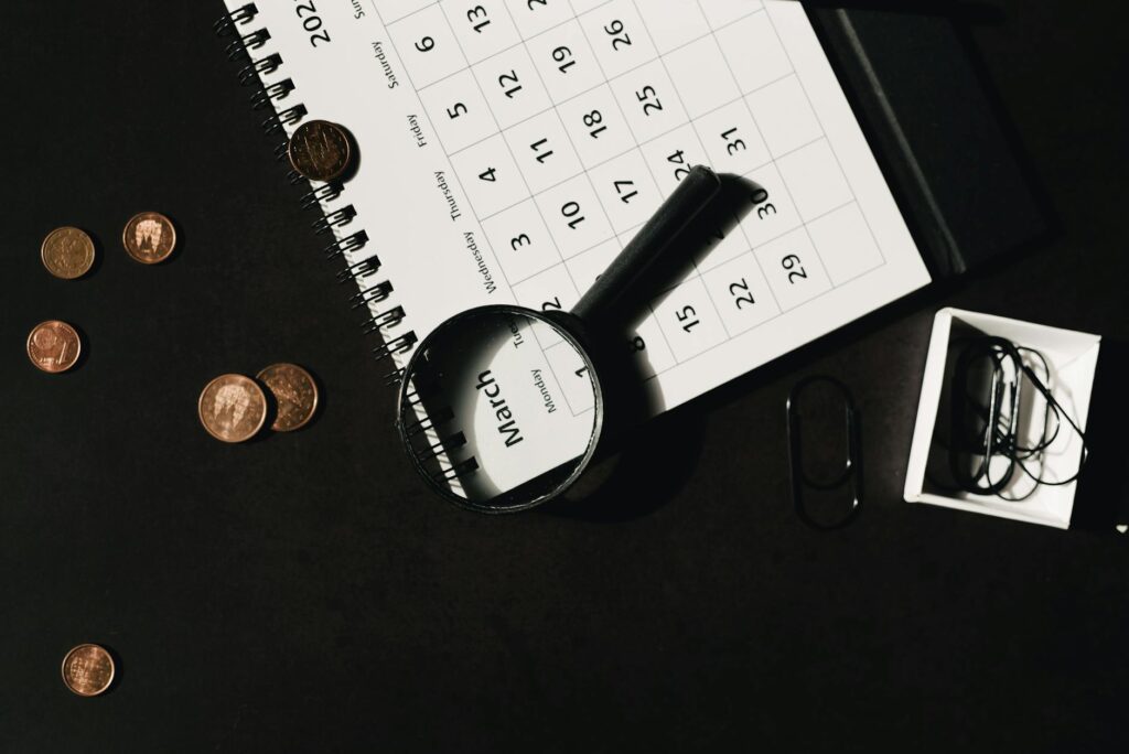 A monthly calendar and savings plan worksheet on a desk