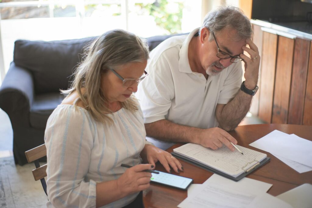 Household paperwork and a brokerage statement spread across a kitchen table