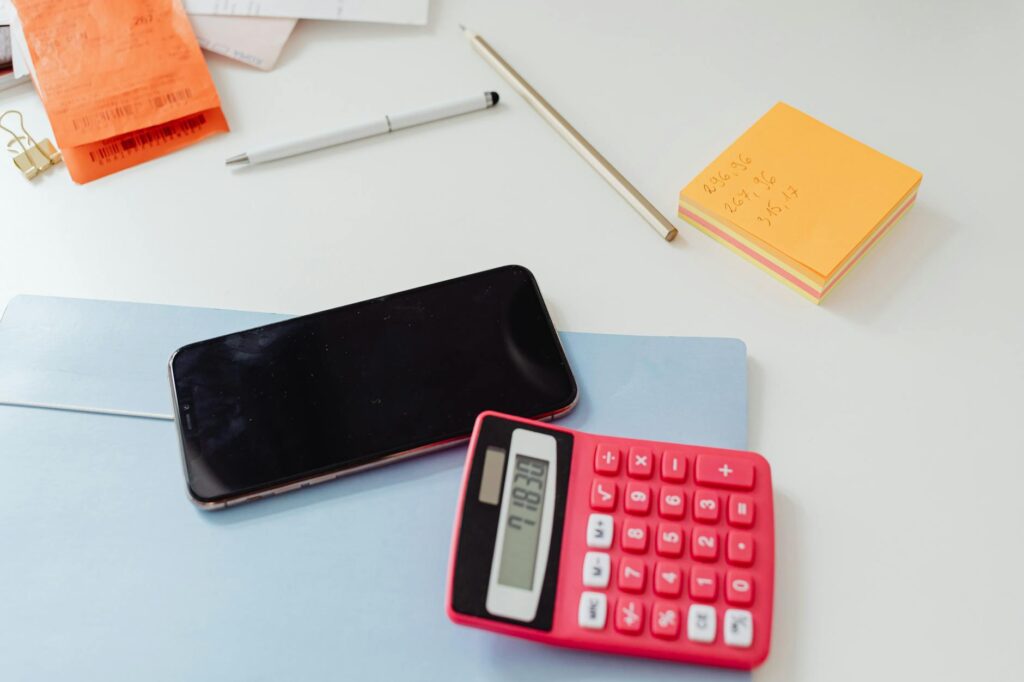 Calculator, retirement account statement, and notes on an organized desk
