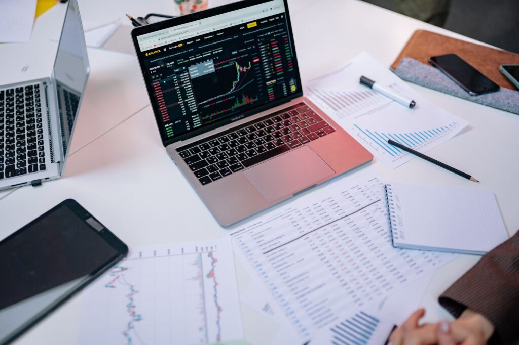 Notebook with an asset allocation plan beside a laptop on a desk