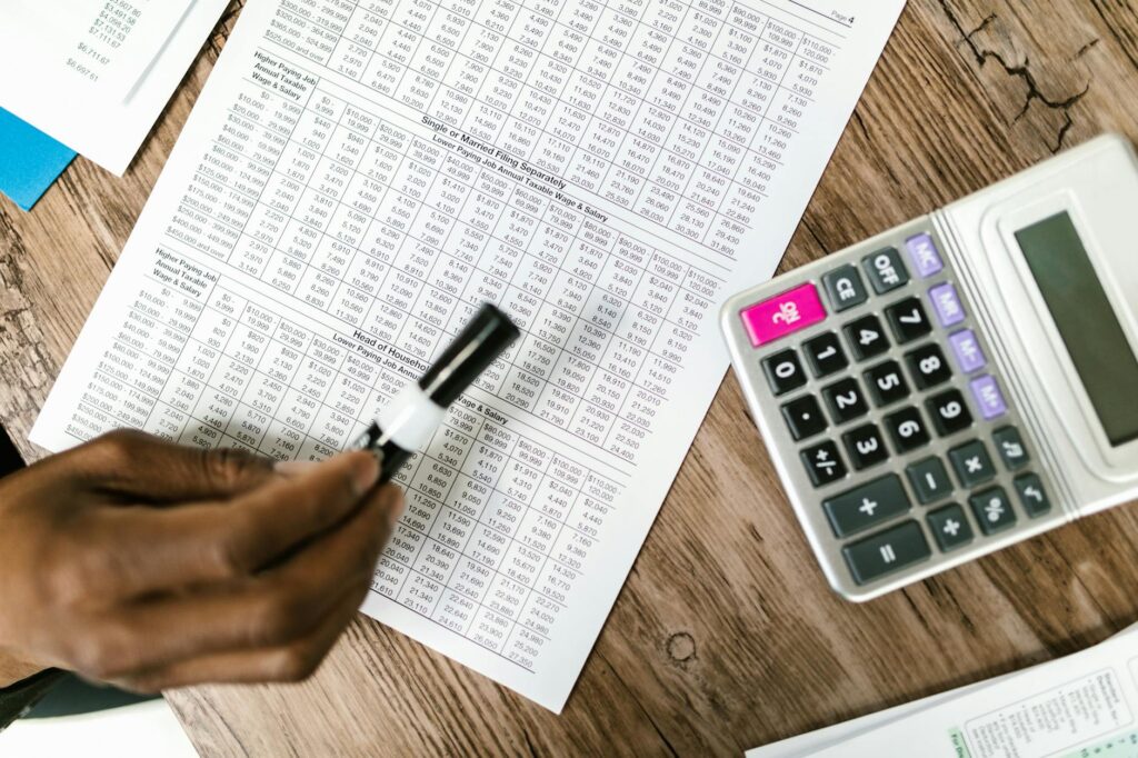 Person reviewing a retirement plan fee disclosure with a calculator