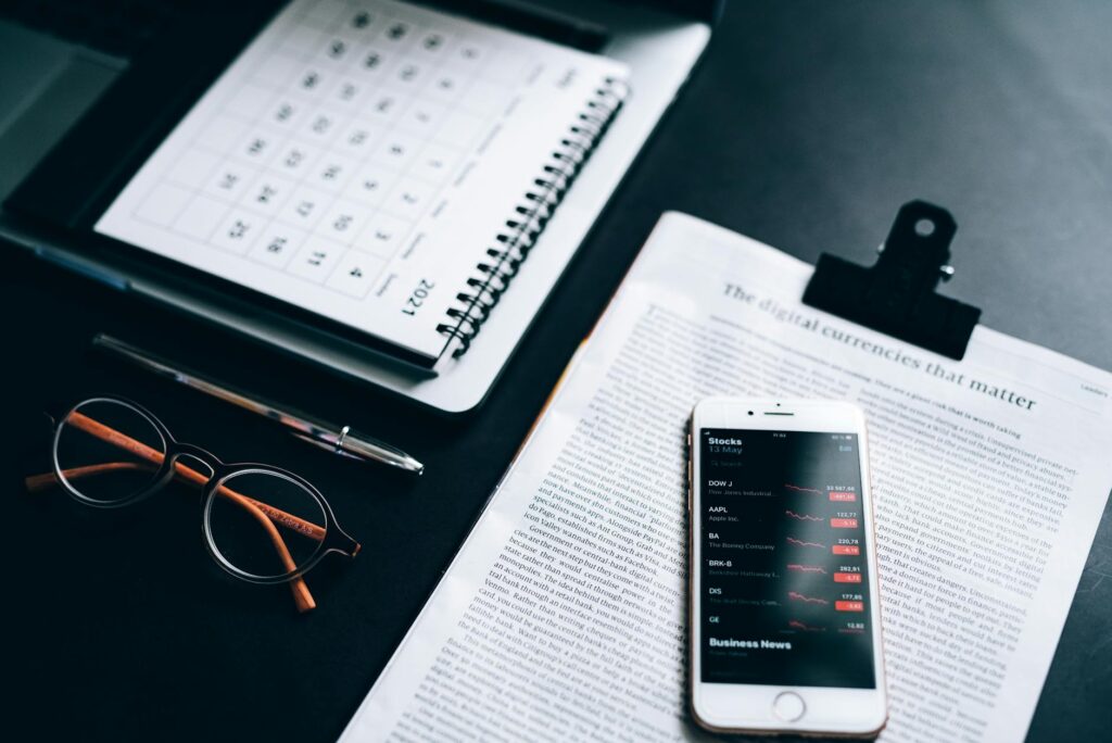 An organized desk with a calendar, notebook, and financial papers