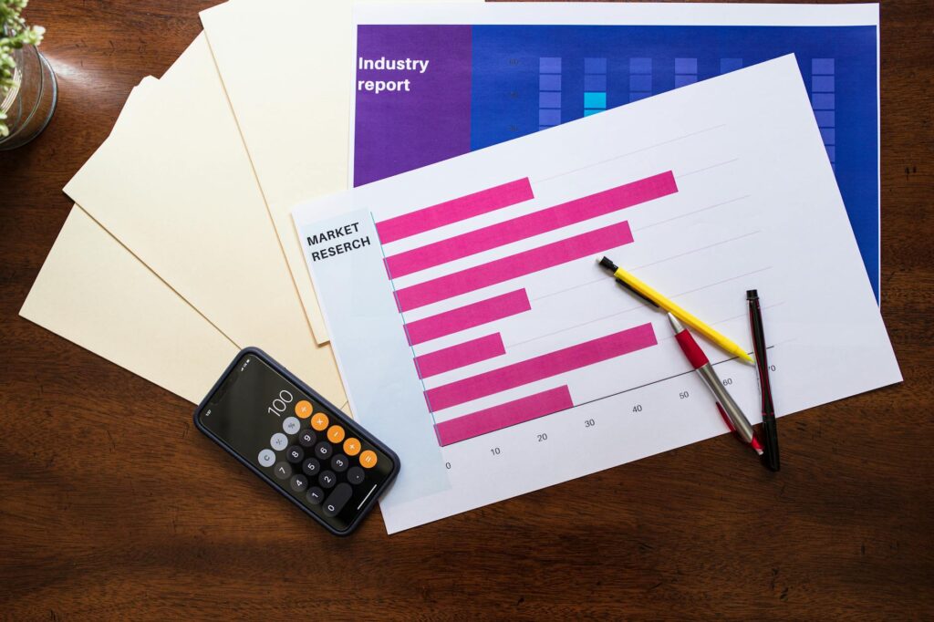A retirement planning desk with market papers, bond statements, and a calculator.