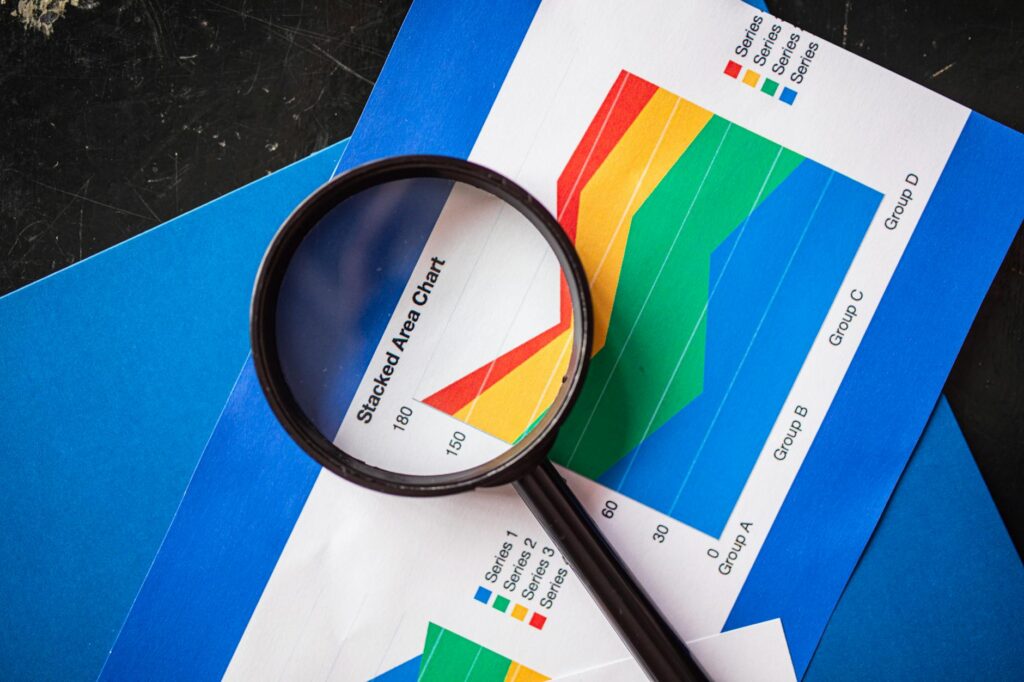 A magnifying glass over fixed-income documents on a desk.