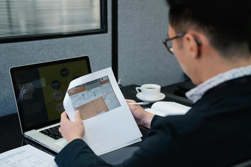 Investment report and laptop on a desk