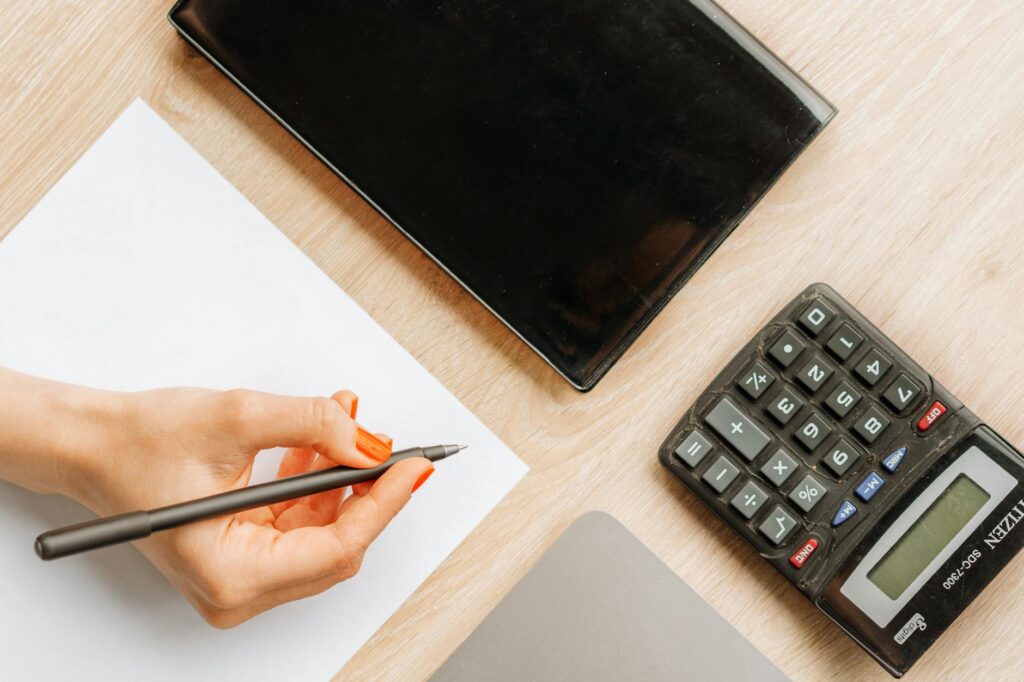 An asset allocation worksheet with a calculator and pen on a clean desk
