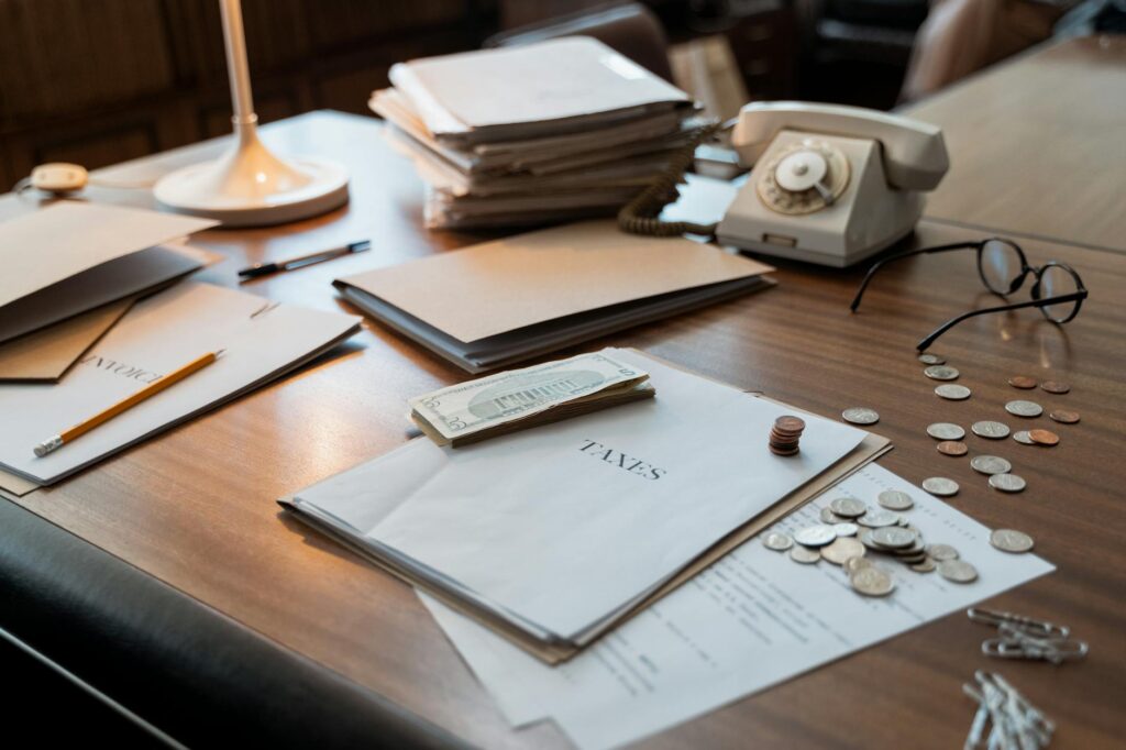 Hands organizing financial paperwork into separate piles on a desk