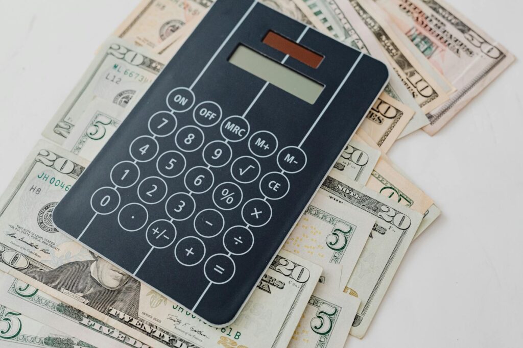 A close-up of a financial worksheet with highlighted fund holdings and a calculator
