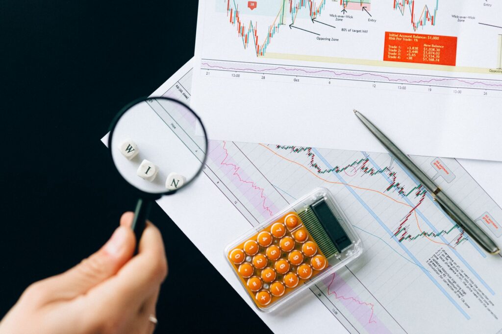 Fund paperwork, a calculator, and a pen arranged for checking fees and fund details.