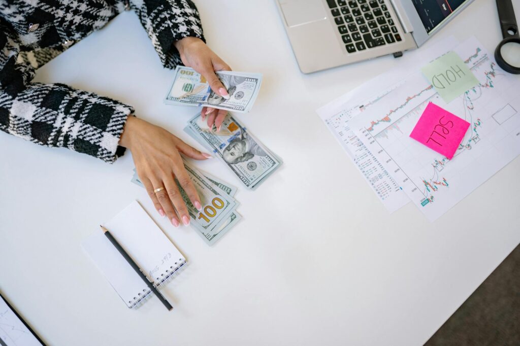 An organized desk with investment statements, a calculator, and notes for a portfolio review