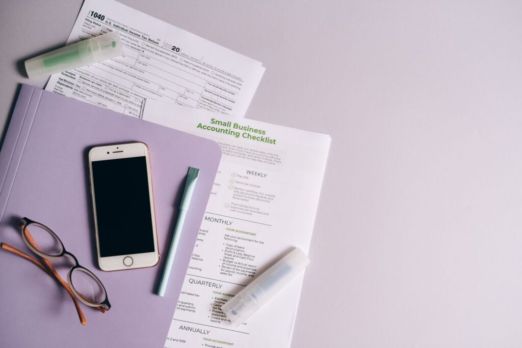Brokerage paperwork with a pen and glasses ready for review