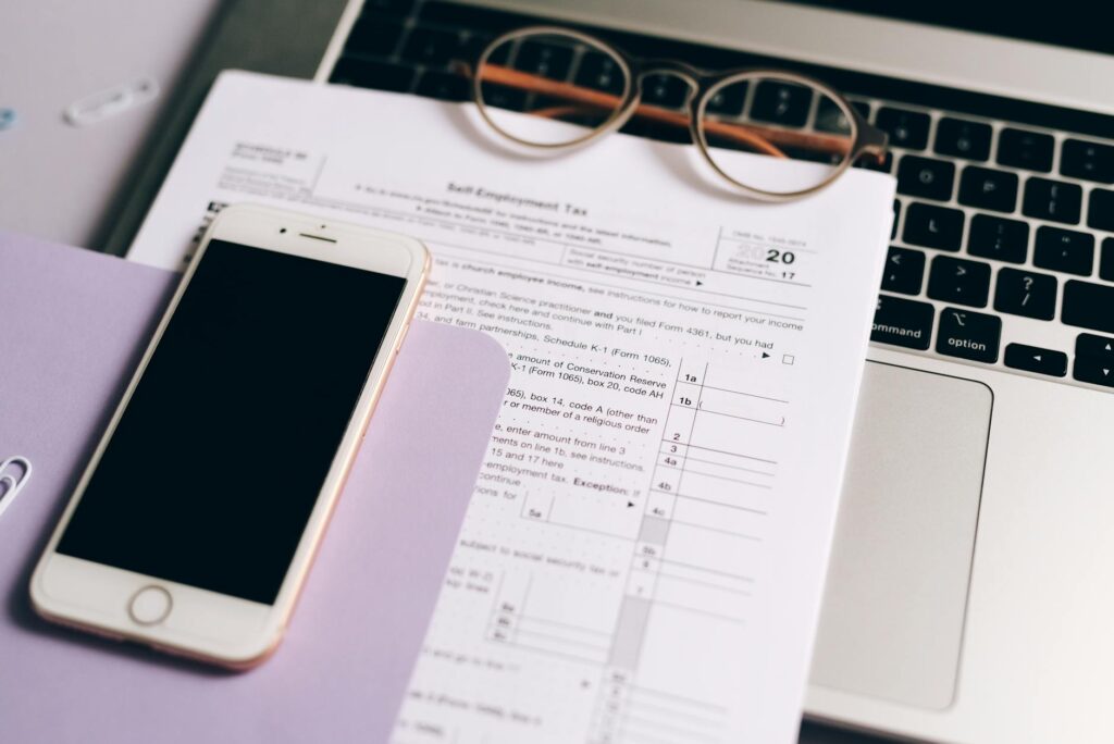 Transfer paperwork, a checklist, and a pen on a financial planning desk.