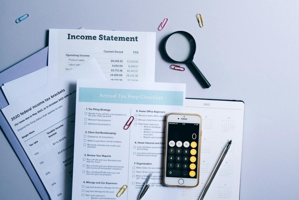 Calendar and checklist placed beside financial paperwork on a desk