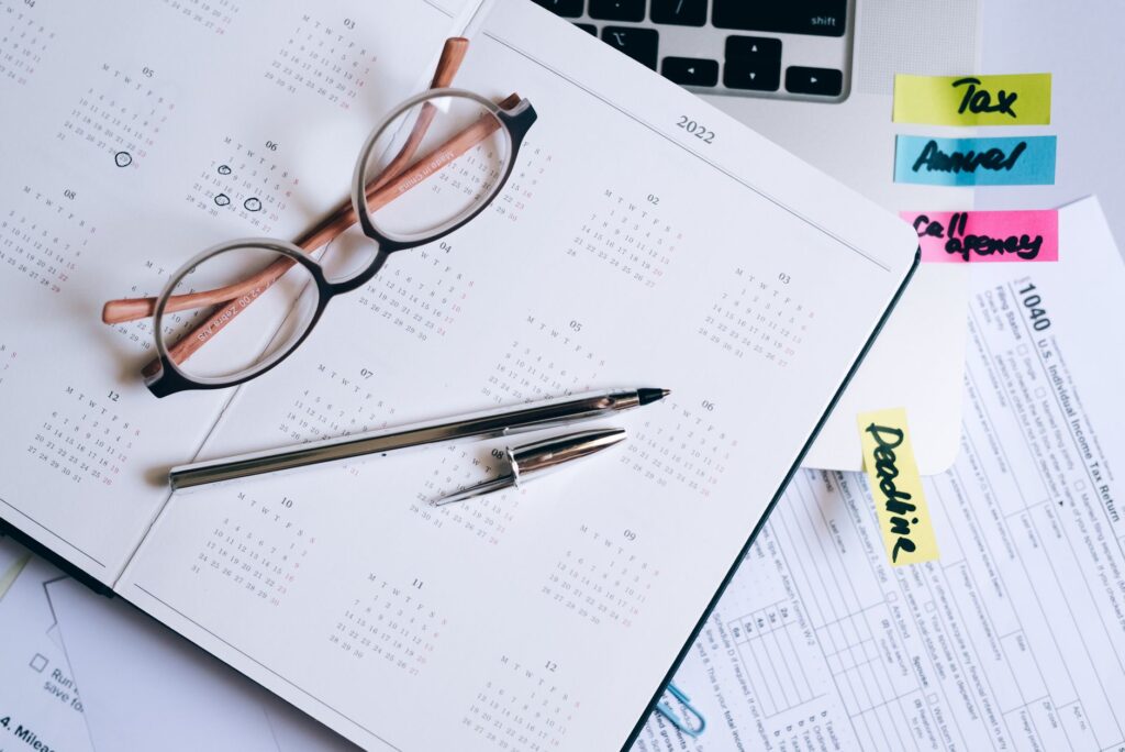 A calendar and checklist on a desk prepared for a scheduled portfolio review